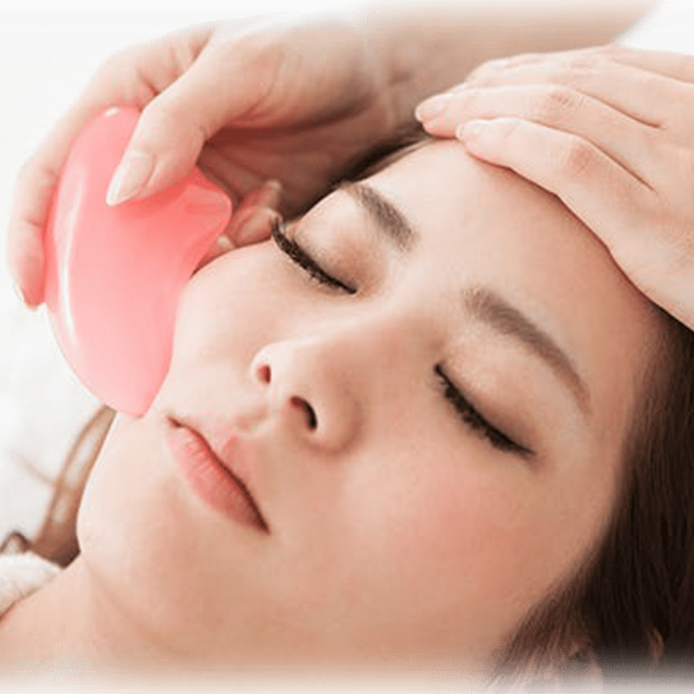 A client undergoing Guasha Intensive Therapy Face Lymphatic Drainage