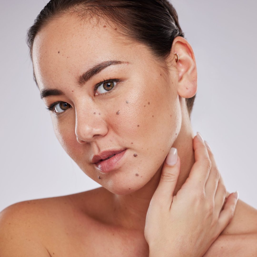 Skincare, face and beauty portrait of a woman in studio for beauty, dermatology and cosmetics for skin. Aesthetic asian model person with makeup glow and facial self care on grey background.
